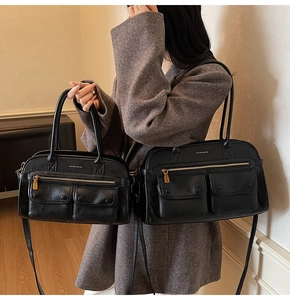 Detail view of large and small black leather tote bags with multiple functional pockets