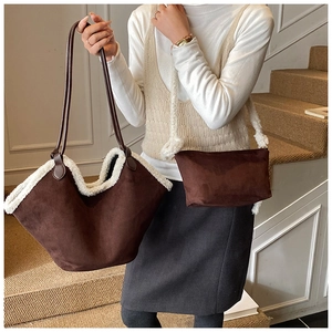 Detail of suede underarm bag set with white faux fur trim and plush shoulder strap
