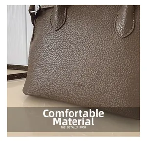 Close-up of brown lychee grain leather shell bag showing detailed texture and stitching