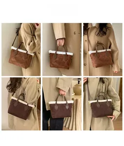 Detail view of vintage brown suede bucket bags with faux shearling trim and embossed pattern