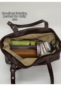 Top view of spacious deep brown tote bag interior with zipper and daily essentials
