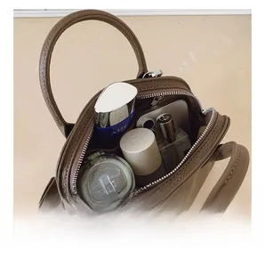 Top view of the interior capacity of dark brown litchi pattern shell crossbody bag