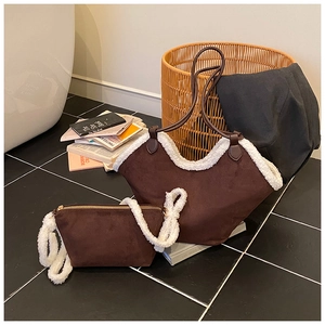 Detail view of brown suede tote and crossbody bag set with white faux shearling trim