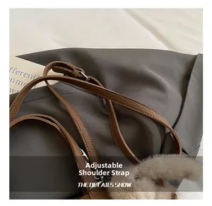 Detail of adjustable brown litchi grain leather strap with a cute plush bunny charm