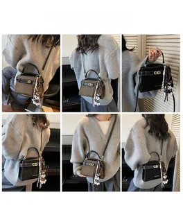 Detailansicht der quadratischen Vintage-Tasche mit Bärenanhänger und Seidenbandverzierung