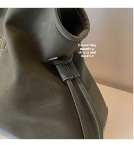 Detail of grey tote bag drawstring closure with metal eyelets and reinforced stitching