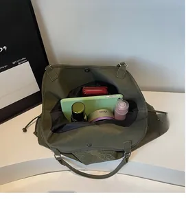 Top view of olive green tote bag showing spacious interior with tablet and cosmetics
