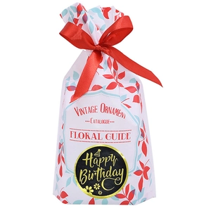 Sac cadeau floral avec nœud en satin rouge et autocollant doré Happy Birthday