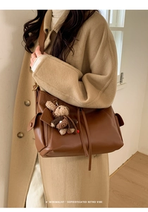 Détail de texture du sac rétro marron avec un joli pendentif de lapin en tricot doux
