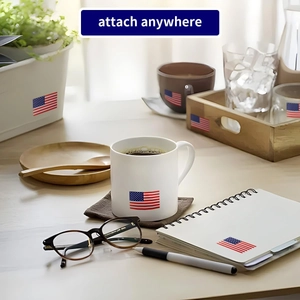 Square USA flag stickers applied on a mug, tray, and notebook for Independence Day