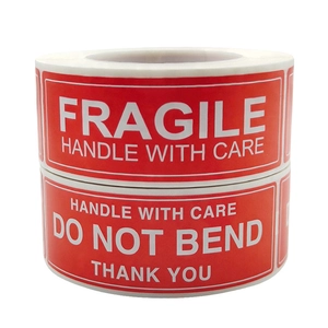 Rolls of red Fragile and Do Not Bend shipping labels with bold white text on white background