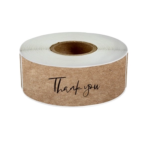 Close-up of brown kraft paper Thank You stickers roll for gift packaging seal