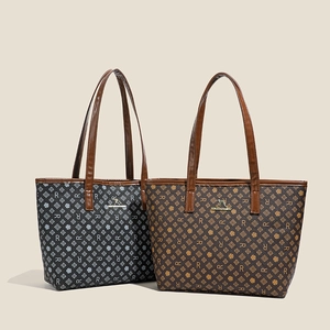 Close-up of retro monogram tote bags featuring gold kangaroo logo and PU leather texture