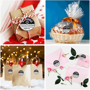 Black circular WARNING stickers for gift packaging shown on various boxes and bags