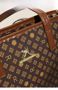 Macro shot of vintage canvas tote with leather handle and golden kangaroo logo detail