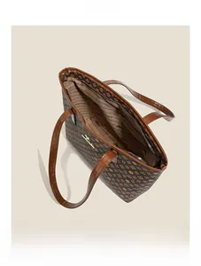 Top view of open monogram tote bag showing spacious interior and branded lining