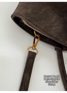 Detail of vintage textured leather tote with detachable shoulder strap and bronze hook
