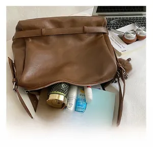 Detail view of large dark brown leather tote interior with spacious storage compartments