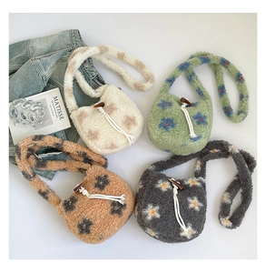 Vue à plat de quatre sacs seaux en peluche fleurie avec des détails de boutons en bois