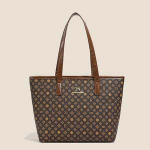 Detail of brown monogram tote bag featuring leather texture and golden kangaroo logo