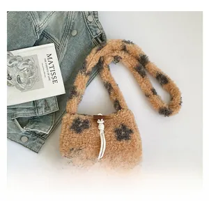 Detail of plush bucket bag with star patterns, white drawstring and olive toggle closure