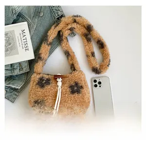 Detail of plush leopard print crossbody bag with toggle closure and drawstring