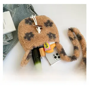 Detailed interior view of leopard print plush bag showing phone and lipstick storage