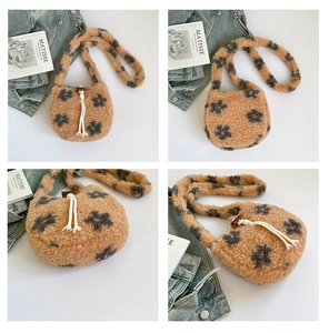 Close-up of fluffy khaki faux fur bucket bag with floral patterns and drawstring tassel detail