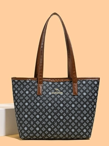 Minimalist large tote bag with geometric R patterns and brown leather handles