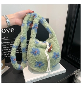 Detail of floral plush bucket bag with horn buckle and drawstring closure