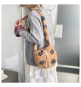 Close-up of plush bucket bag with horn buckle and soft faux fur floral texture