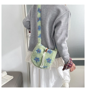 Detail of plush lamb wool bucket bag with blue floral patterns and drawstring closure