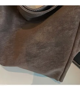 Detail of coffee brown tote bag showing the soft texture and high-quality faux leather