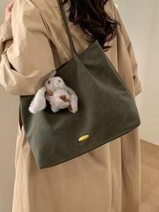 Olive green suede tote bag for women with gold emblem and plush rabbit keychain