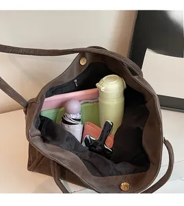 Spacious interior of brown faux leather tote bag showing large storage capacity