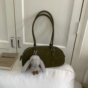 Olive green suede Boston bag with silver zipper and cute plush bunny charm