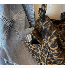 Close-up of camouflage leopard tote side pocket with a water bottle for storage