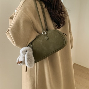 Olive green suede Boston shoulder bag detail featuring a cute plush bunny charm accent