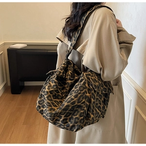 Close-up of leopard print canvas tote bag showing spacious capacity and wide strap