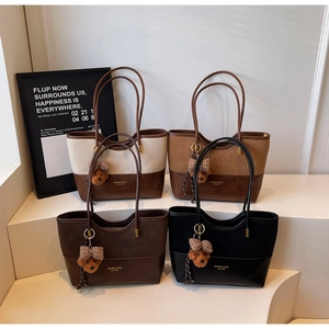 Detailed view of four retro patchwork tote bags in cream, brown, and black with plush charms