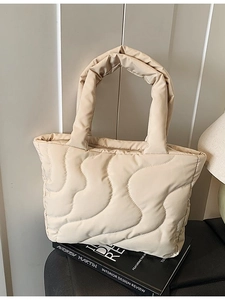 Chic quilted down tote bag in cream white with wide wave stitching and fixed handles
