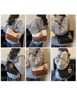 Multiple views of a vintage color-block tote bag with a plush bear charm on a model