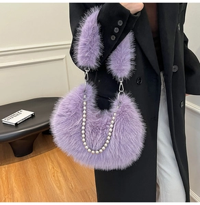 Close-up of purple faux fur bag with metallic silver beaded chain and plush handle detail