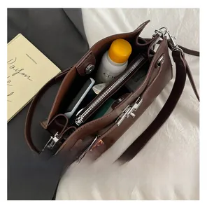 Interior view of brown vintage tote bag showing large capacity with middle zipper pocket