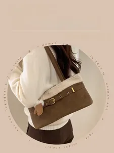 Close-up of vintage brown suede and white faux fur shoulder bag with leather buckle detail