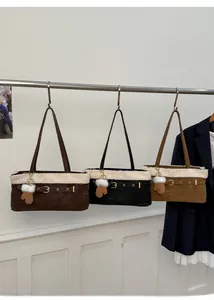 Detail of winter plush trim shoulder bags in coffee, black and camel with cute charms