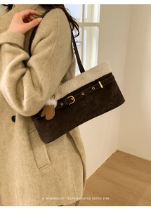 Detail of winter shoulder bag with dark brown suede texture and white plush trim
