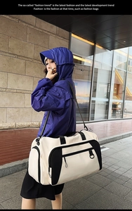 Detailed view of large travel bag with reinforced straps and contrast nylon material