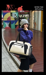 Detail of large canvas travel bag with side mesh pocket and adjustable nylon strap
