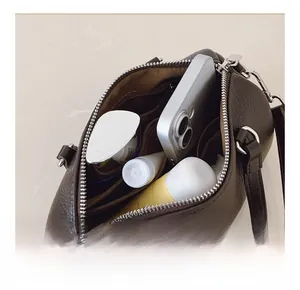 Interior view of brown lychee grain leather handbag showing large capacity and pockets